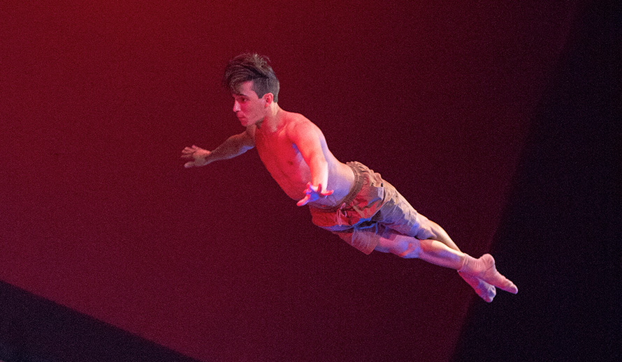 Dancer photographed in mid-air leap.